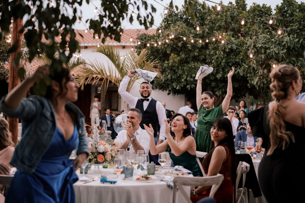 guests dancing with napkins during wedding dinner